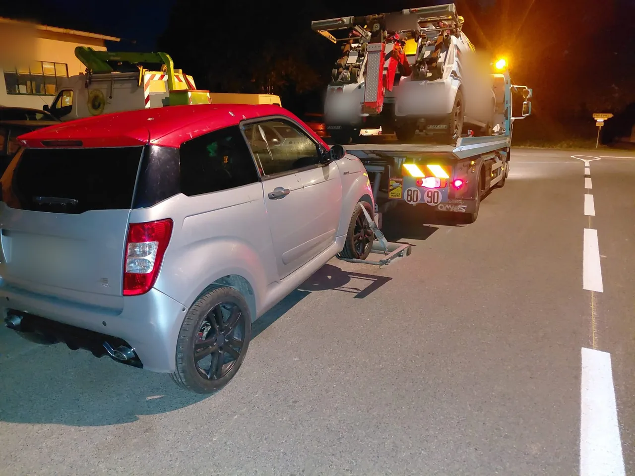 Remorquage de nuit d'une voiture sans permis derrière un camion plateau à Trégunc (Finistère)